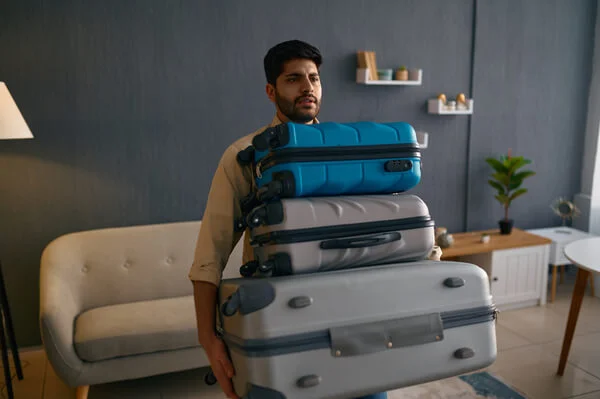 Man carrying heavy luggage